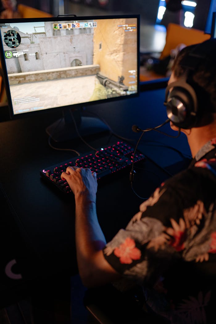 Offerings A young man in a floral shirt is focused on a gaming session, highlighting immersive entertainment.